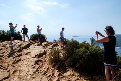 Group of people photographing on beach