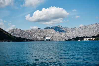 Scenic view of sea and mountains against sky