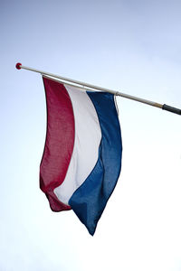 Low angle view of dutch flag against sky