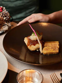 Cropped hand of woman having food