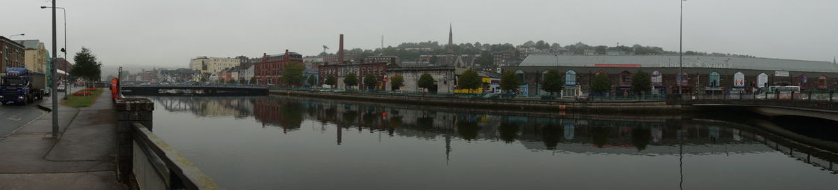 Panoramic view of river by buildings against sky