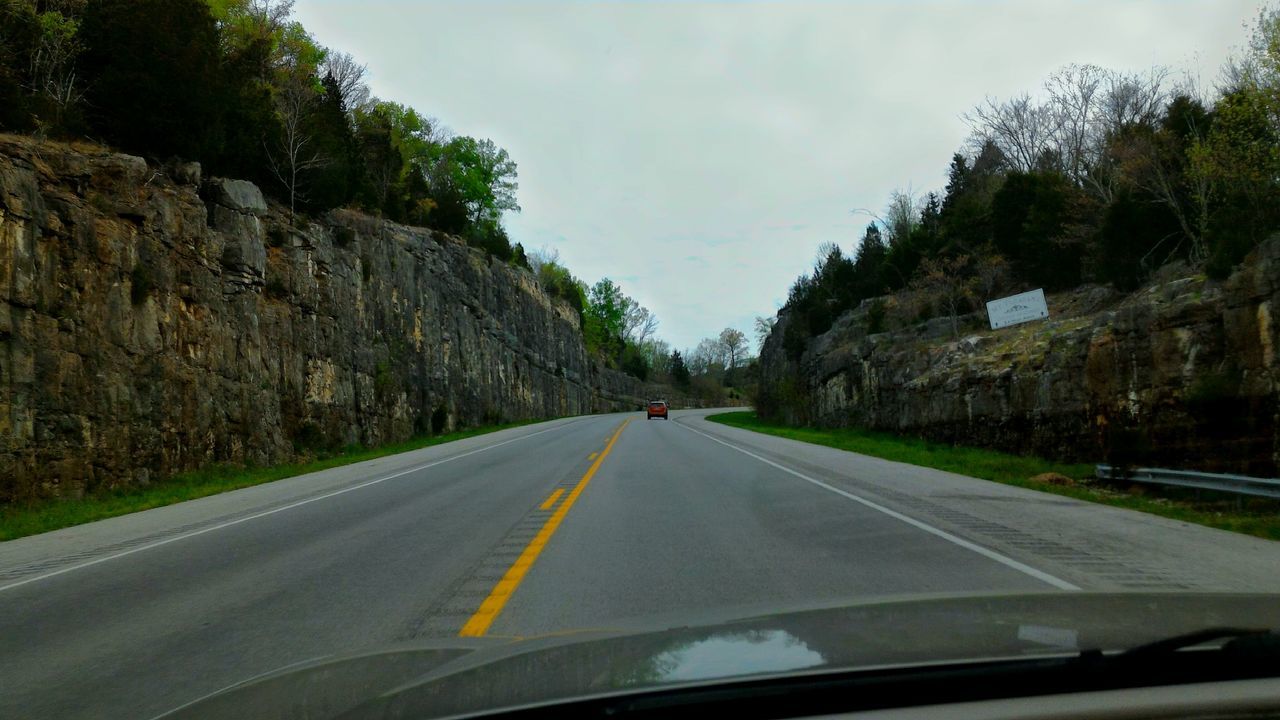 transportation, road, road marking, the way forward, car, mode of transport, land vehicle, sky, mountain, country road, diminishing perspective, tree, vanishing point, cloud - sky, street, travel, on the move, windshield, asphalt, cloud