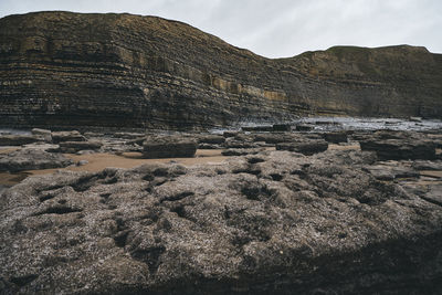 Scenic view of rock formations against sky in  dunraven bay, wales