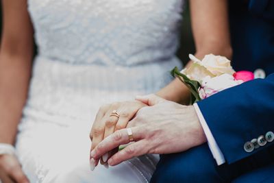 Midsection of couple holding hands