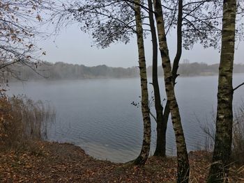 Scenic view of lake against sky at sunset