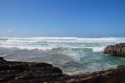 Scenic view of sea against blue sky