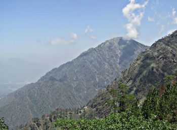 Scenic view of mountains against cloudy sky
