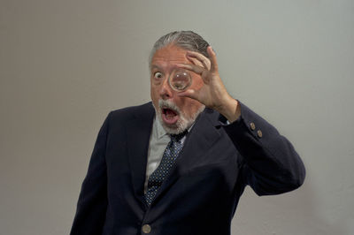 Portrait of man wearing hat against gray background