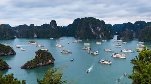 Scenic view of sea and mountains against sky