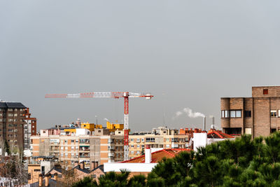 Buildings in city against clear sky