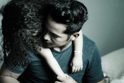 Rear view of couple sitting at home