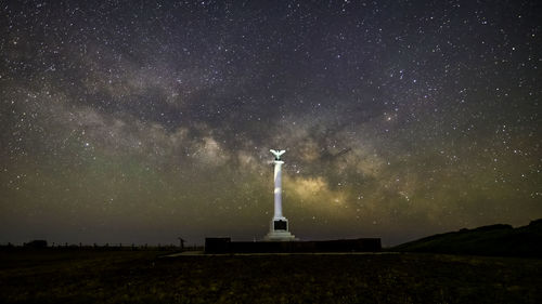 Low angle view of lighthouse against sky at night