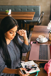 Girl looking at photos of the memory while planning a summer trip