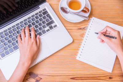 High angle view of woman using laptop on table