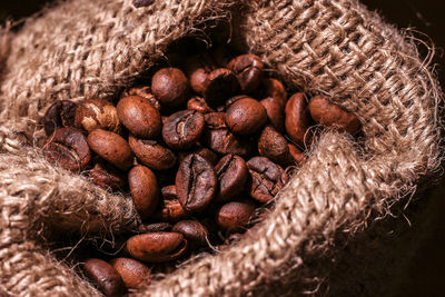 High angle view of roasted coffee beans in sack