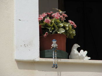 Close-up of white flower vase against wall