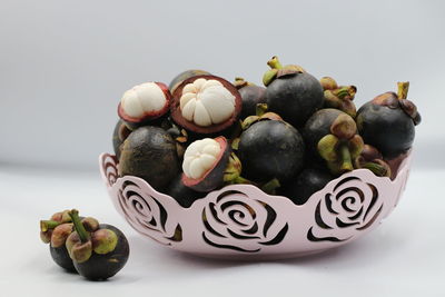 Close-up of fruits on table against white background