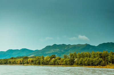 Scenic view of mountains against blue sky