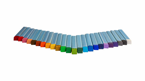 High angle view of multi colored pencils against white background