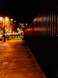 Illuminated corridor in city at night