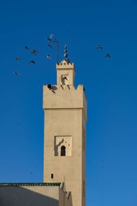 Low angle view of mosque against blue sky