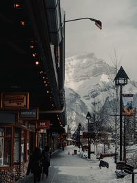 People on snow covered mountain against sky