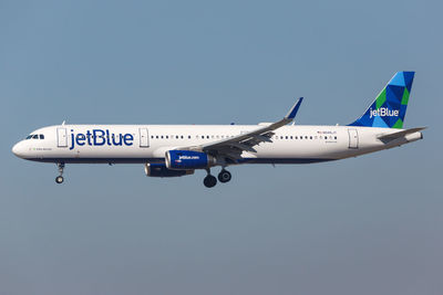 Airplane flying against clear blue sky