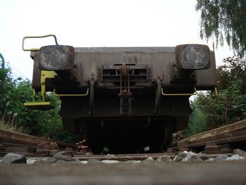 Abandoned train on railroad track against sky