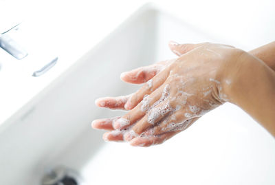 Close-up of person hand in bathroom