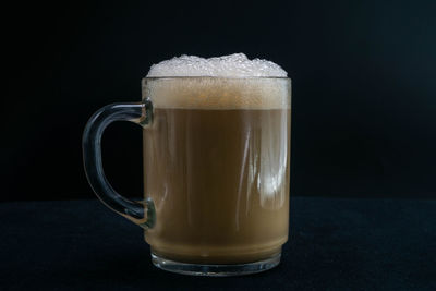 Close-up of coffee cup against black background