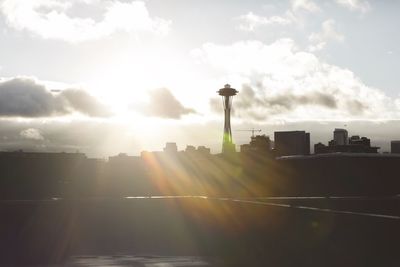 Silhouette buildings in city against sky