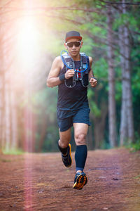 Full length of man running in forest