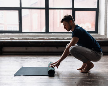 A man engaged in yoga and meditation, performing asanas