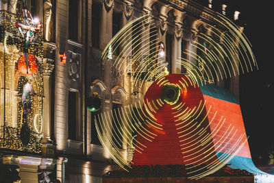 Low angle view of illuminated ferris wheel at night