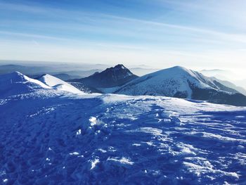 Scenic view of snowcapped mountains against sky