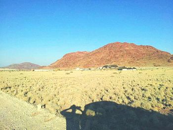 View of desert against clear blue sky