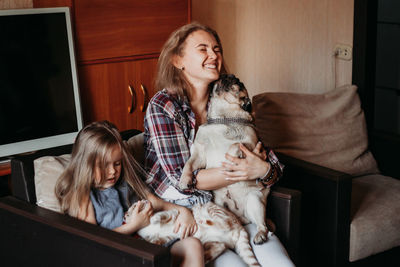 Portrait of happy girl sitting on floor