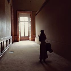 Rear view of woman standing in building