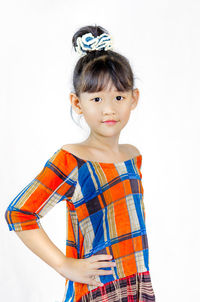 Cute girl standing against white background