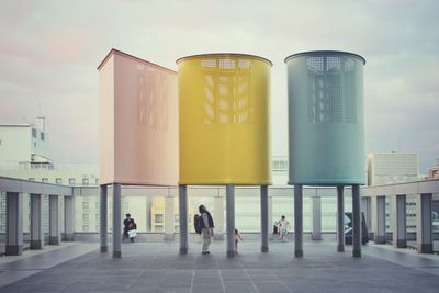 People in city against sky