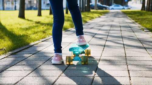 Low section of person standing on footpath