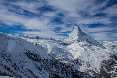 Scenic view of snowcapped mountains against sky