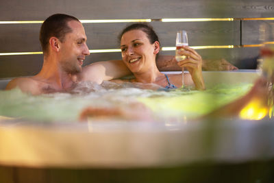 Couple bathing in hot tub