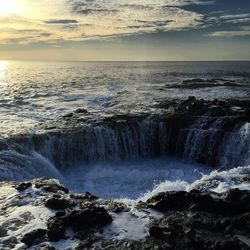 Scenic view of sea against cloudy sky