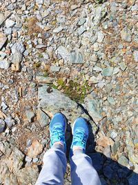 Low section of person standing on rock