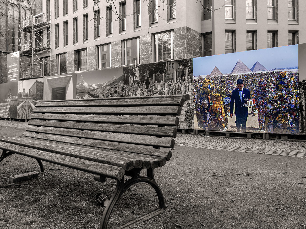 REAR VIEW OF PEOPLE WALKING ON BENCH AGAINST BUILDINGS