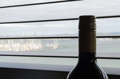 Close-up of glass bottle against sky