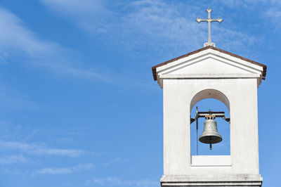 Low angle view of bell tower against sky