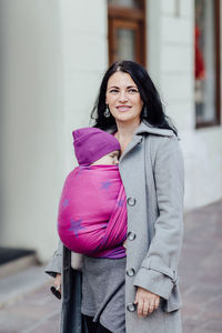 Portrait of a smiling young woman standing outdoors