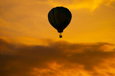 Low angle view of hot air balloon against orange sky